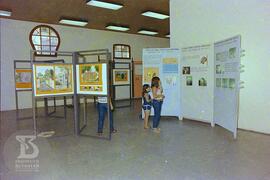 Interior do Museu Biológico, visitantes observando painel expositivo